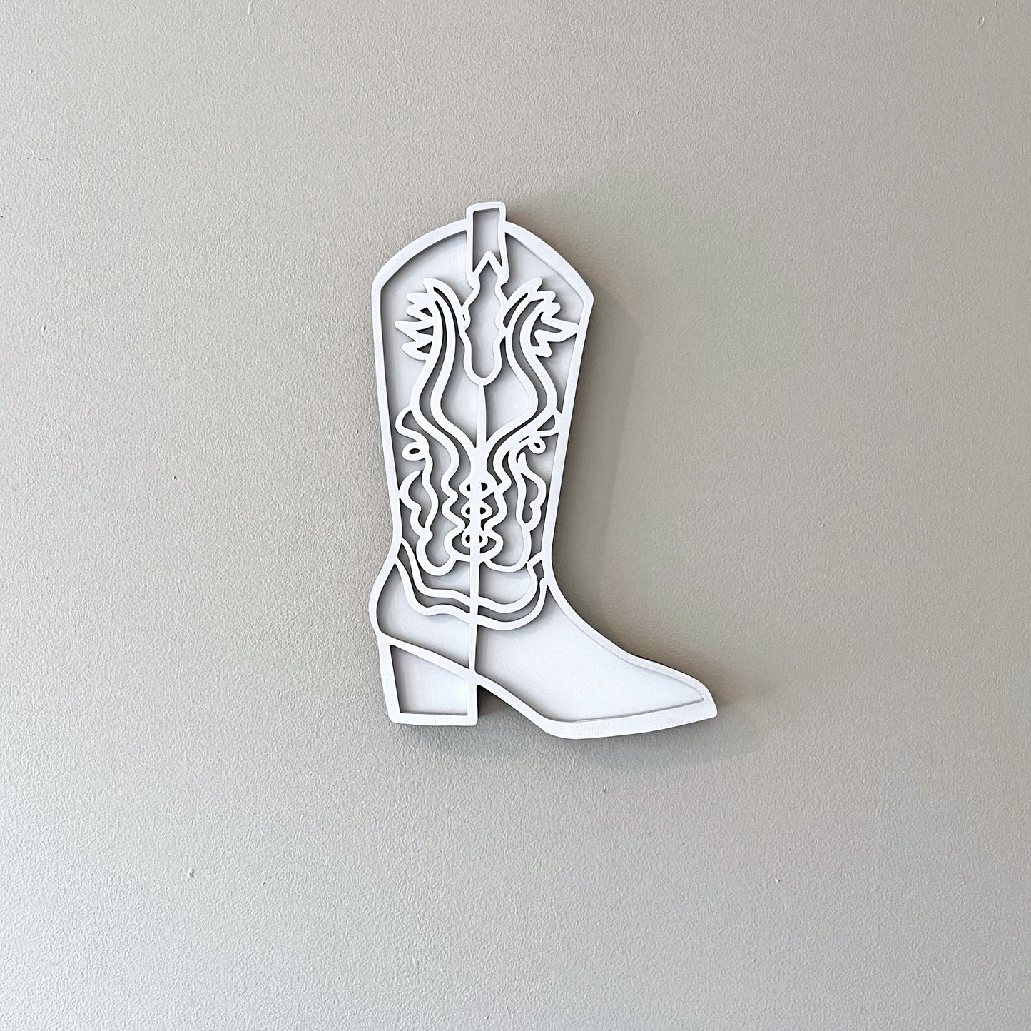 White cowgirl boot wall decor.